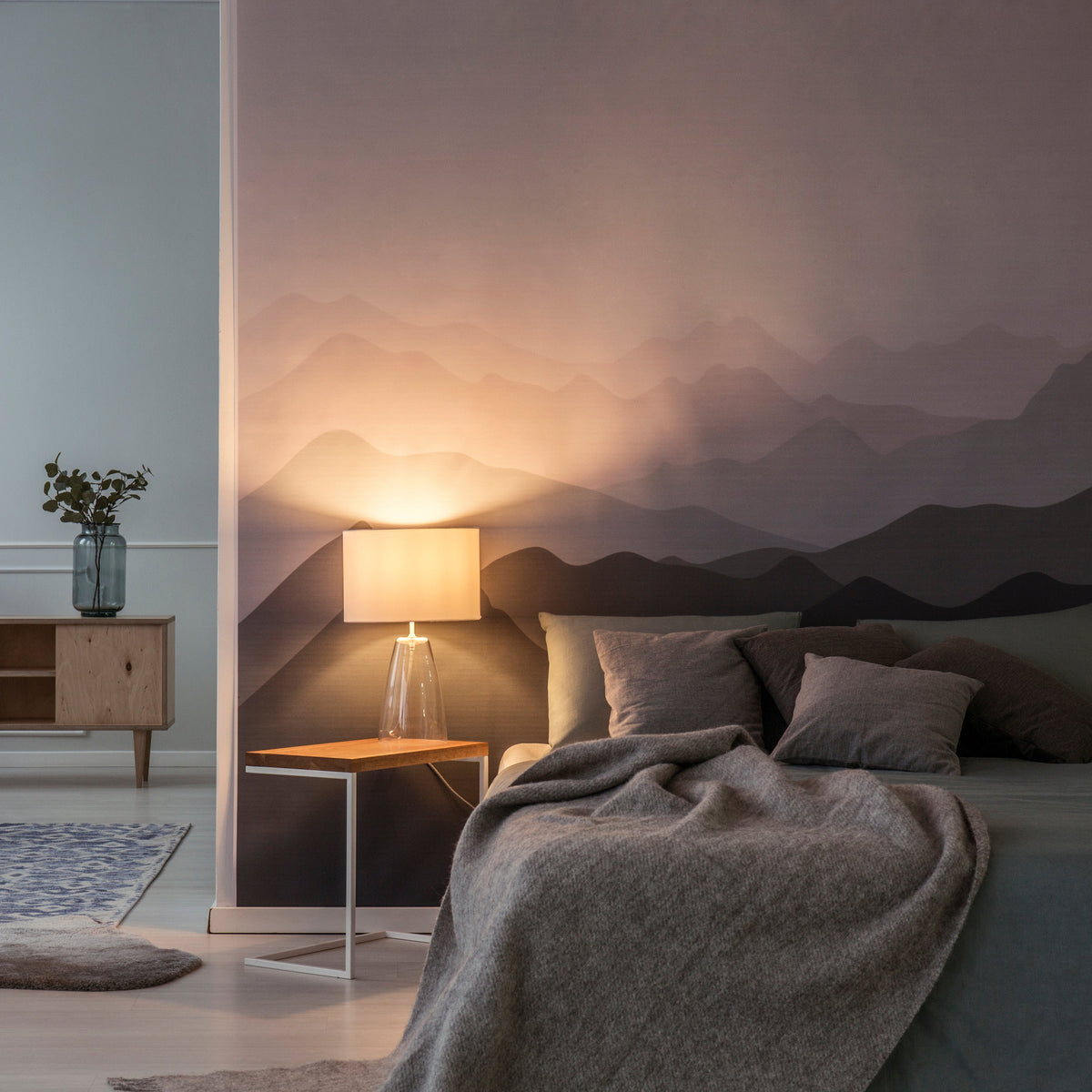Removable self-adhesive printable wallpaper illustrated with a mountain mural in a bedroom.